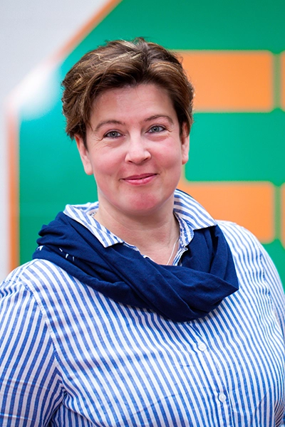 Manuela Müller vor dem Ebrecht Reker Logo